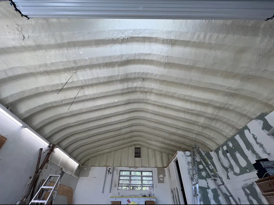 Spray polyurethane foam applied to the underside of a metal roof deck in Springville
